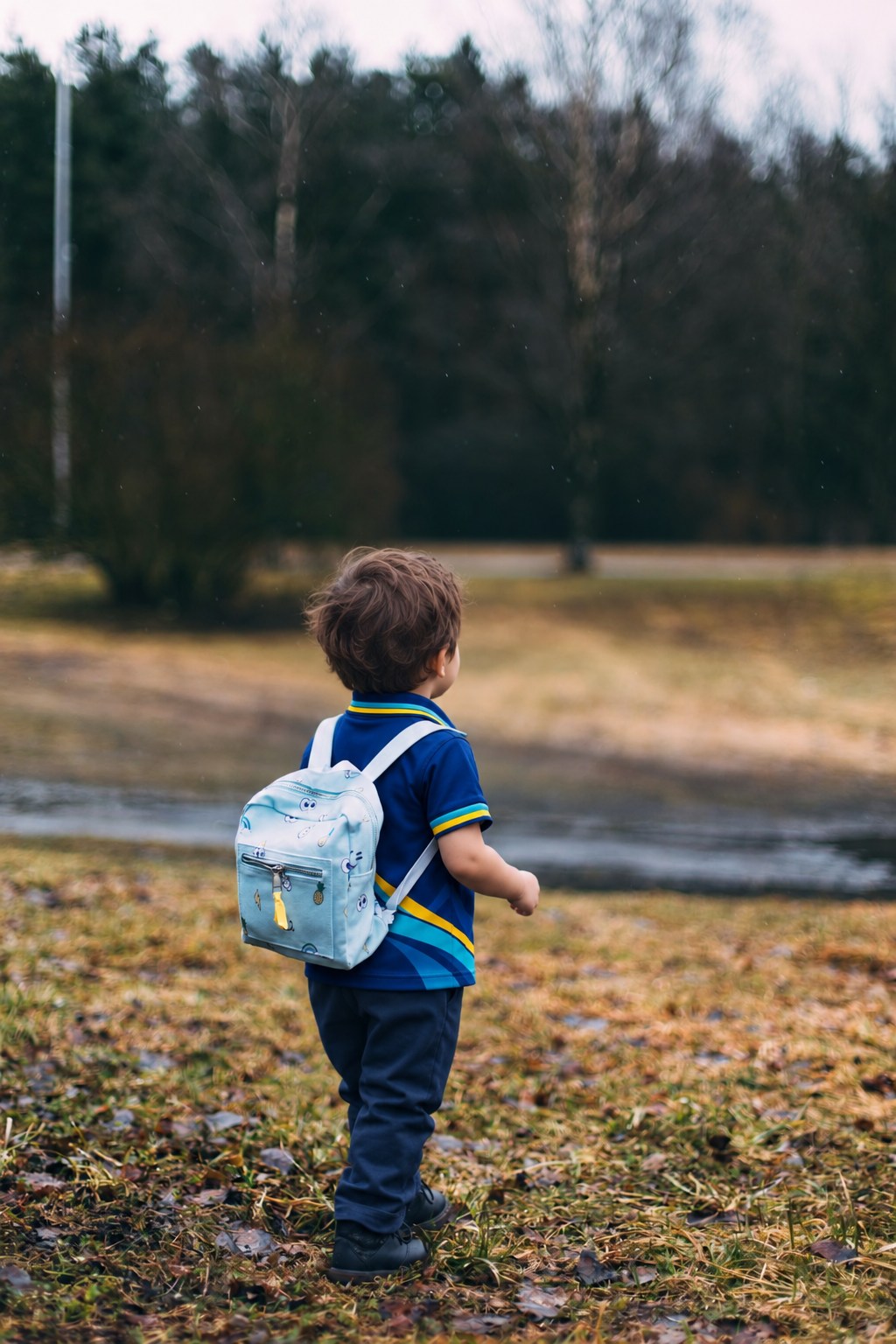 A child in the school uniform exploring outdoors